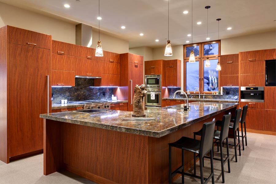 kitchen with marble counters and pendulum lighting