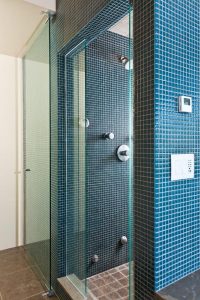 tiled shower with glass door