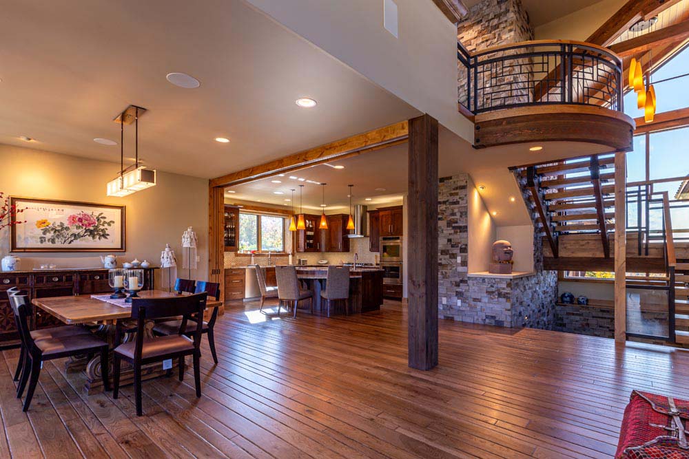 Open floor concept of dining, kitchen and open staircase.