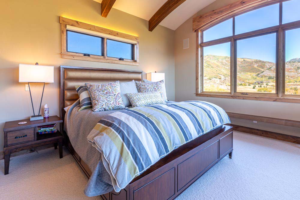 King size bed with nightstand and views mountains outside the window.