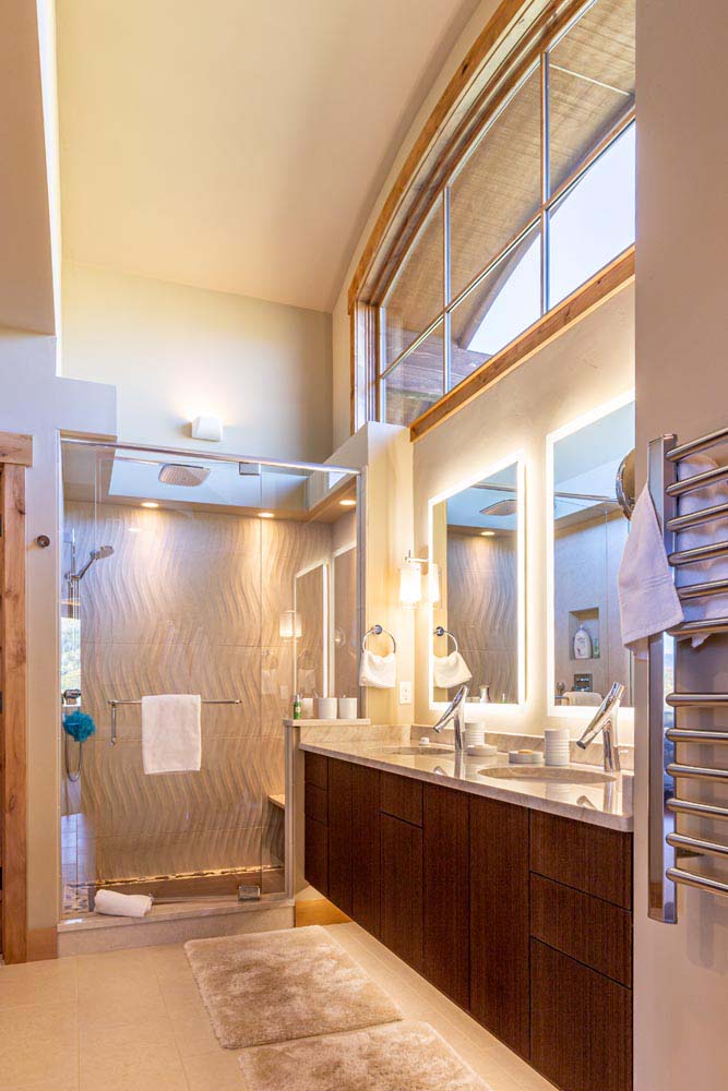 Bathroom with tall ceilings and large windows.