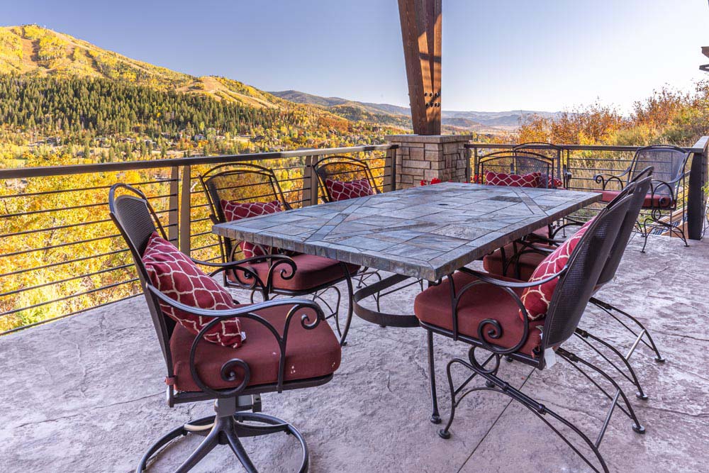 Patio with dining table and view of fall colors on mountain.