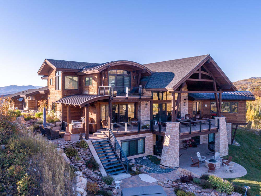 Backyard showing extensive decks and landscaping of a custom mountain home.