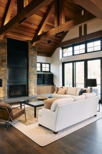 Large ceilings with open beams in living room and fireplace.