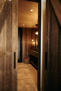 Bathroom with wood lined walls.