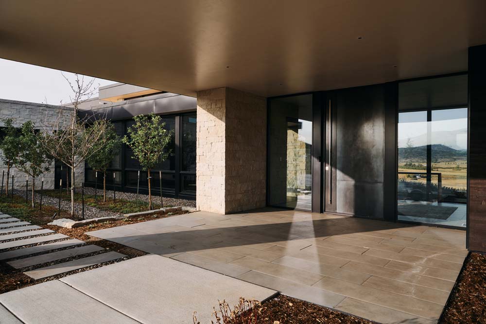 Outside entry into modern home, with zeros-cape and large stepping stones.