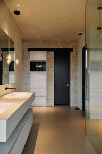 Bathroom with glass shower and wood door.
