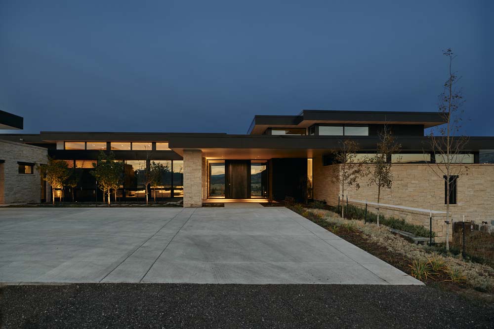 Modern home with large entry at night time.
